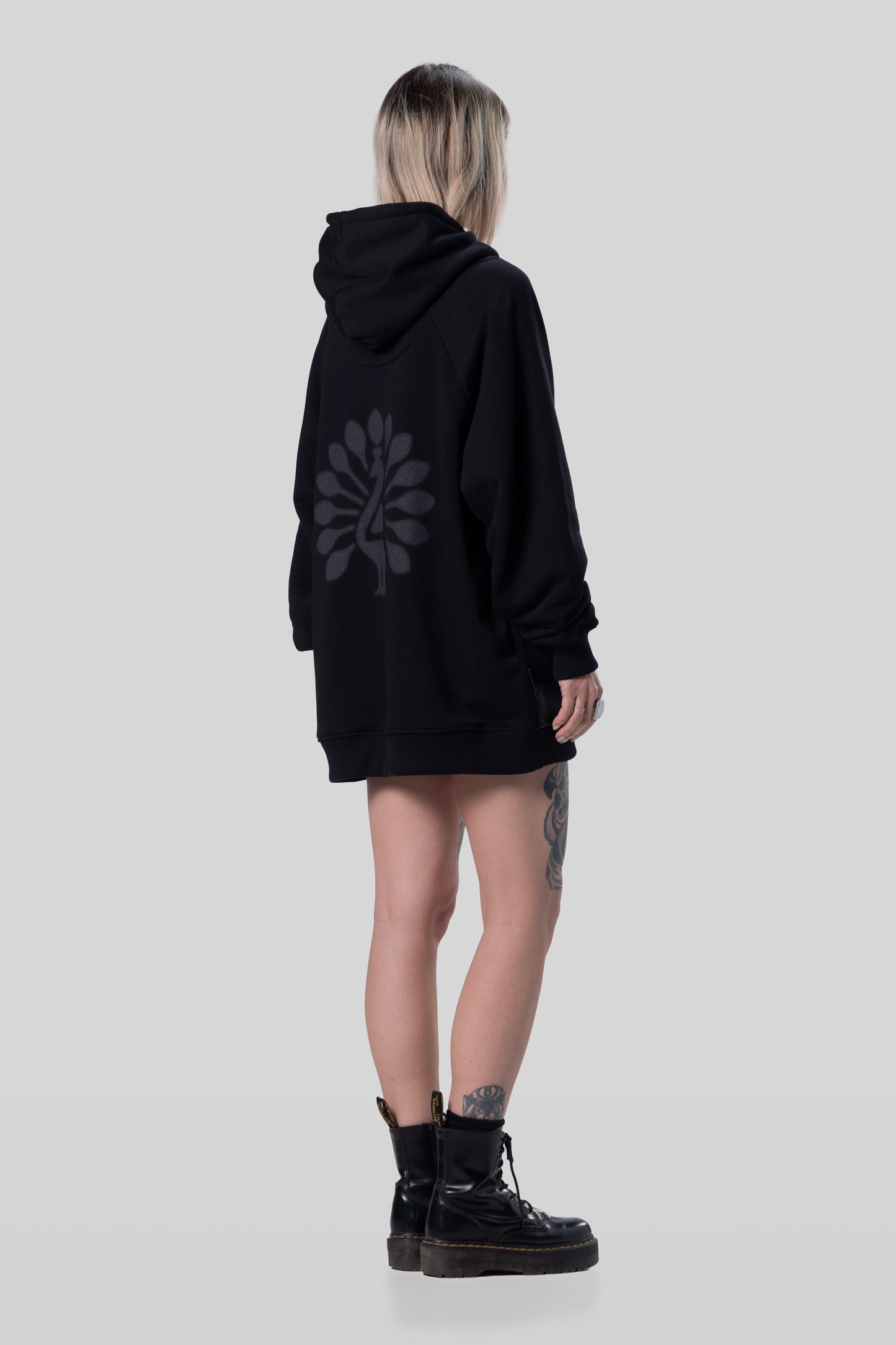 Angled full body back view of Shadow hoodie with peahen print