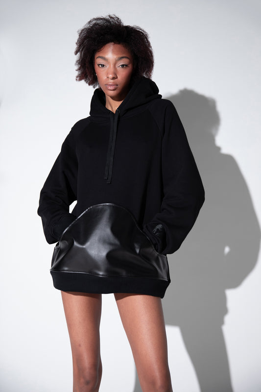 Model wearing 4NML Shadow hoodie in black organic cotton with AppleSkin pouch, relaxed fit