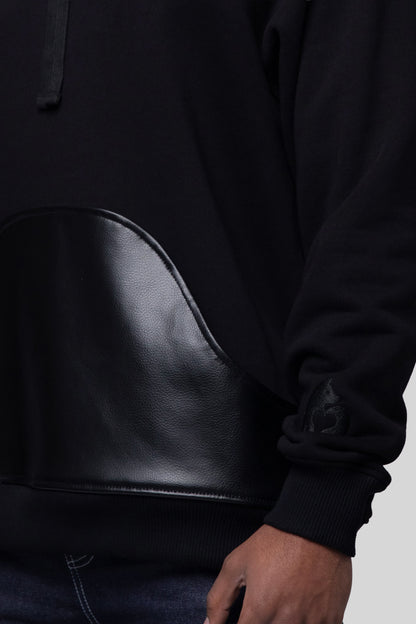 Close-up of AppleSkin front pouch and sleeve embroidery on Shadow hoodie
