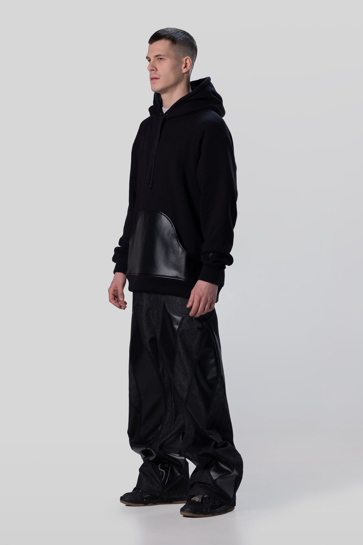 Angled side view of Shadow hoodie in black