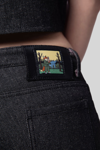 Close-up of fox illustration patch on waistband of Squid jeans