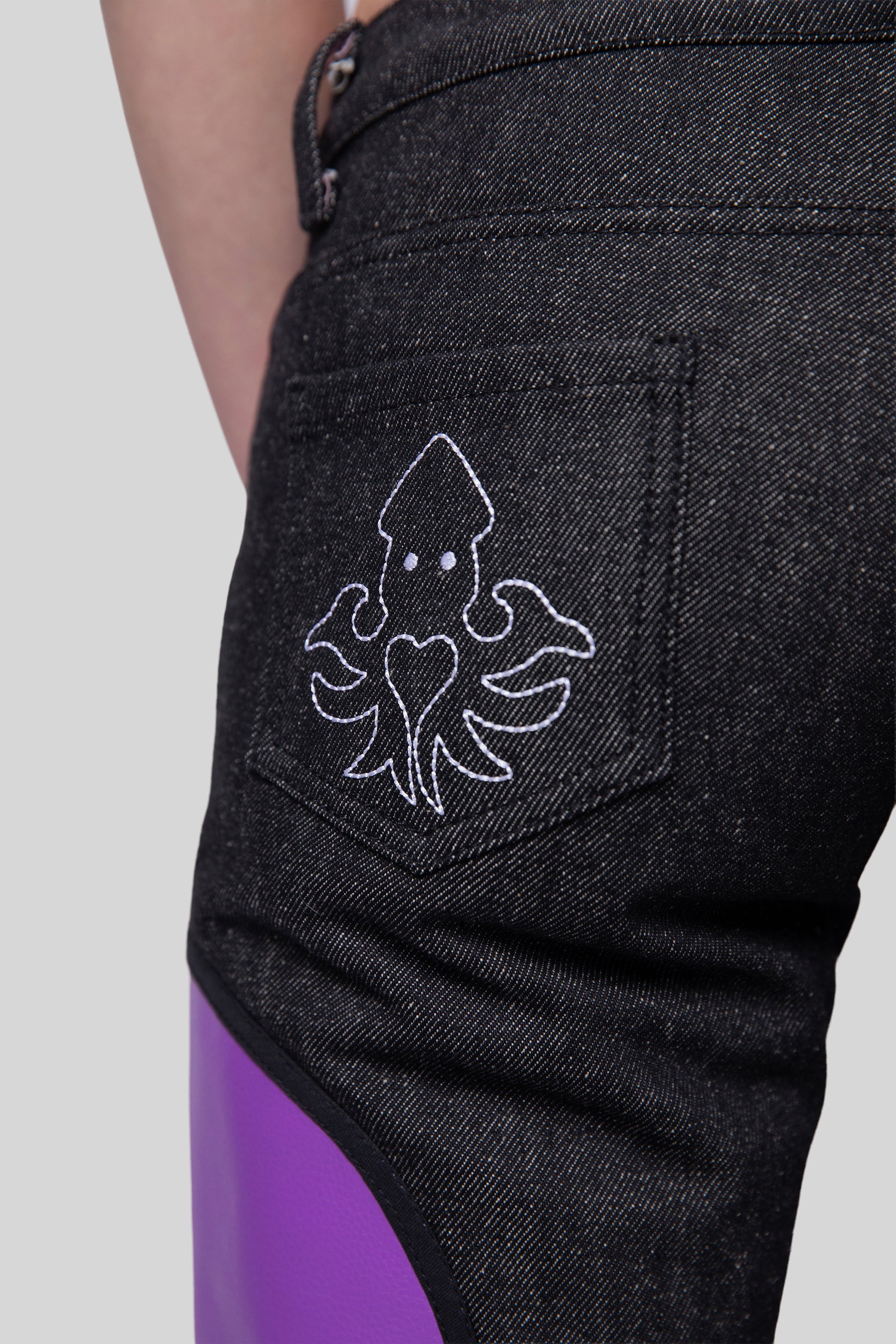 Close-up of squid embroidery on back pocket of Squid jeans