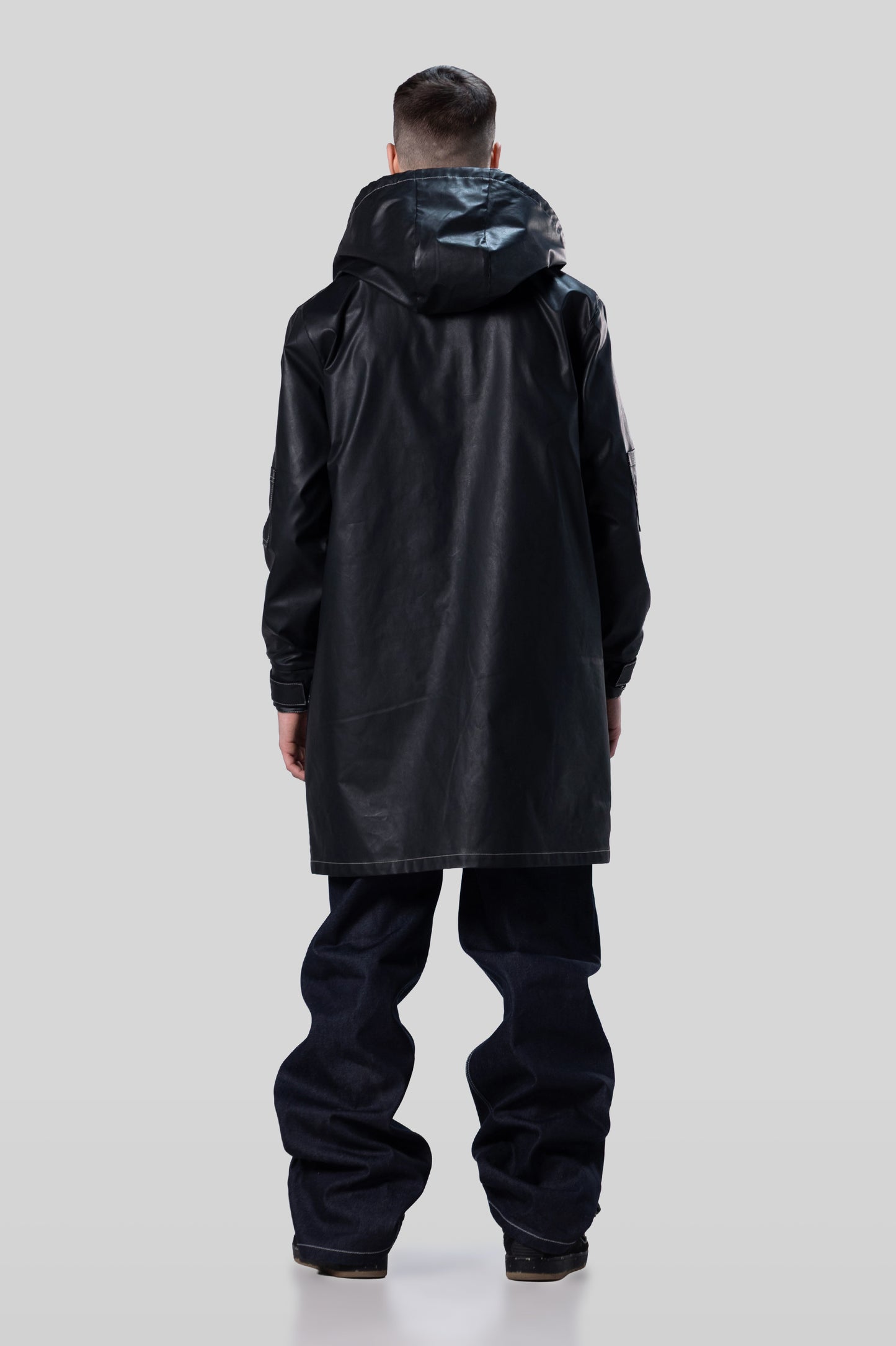 Back view of Totem coat in dark grey with hood