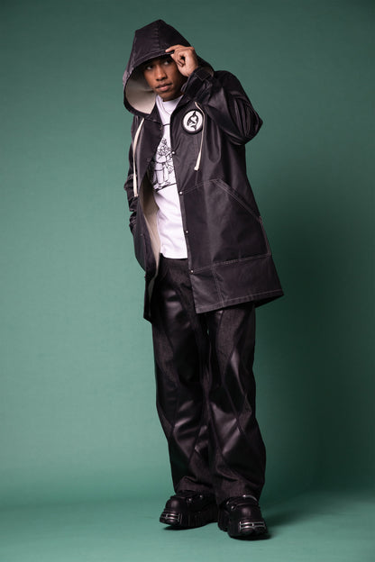 Model wearing Totem coat in dark grey with contrast stitching and structured hood