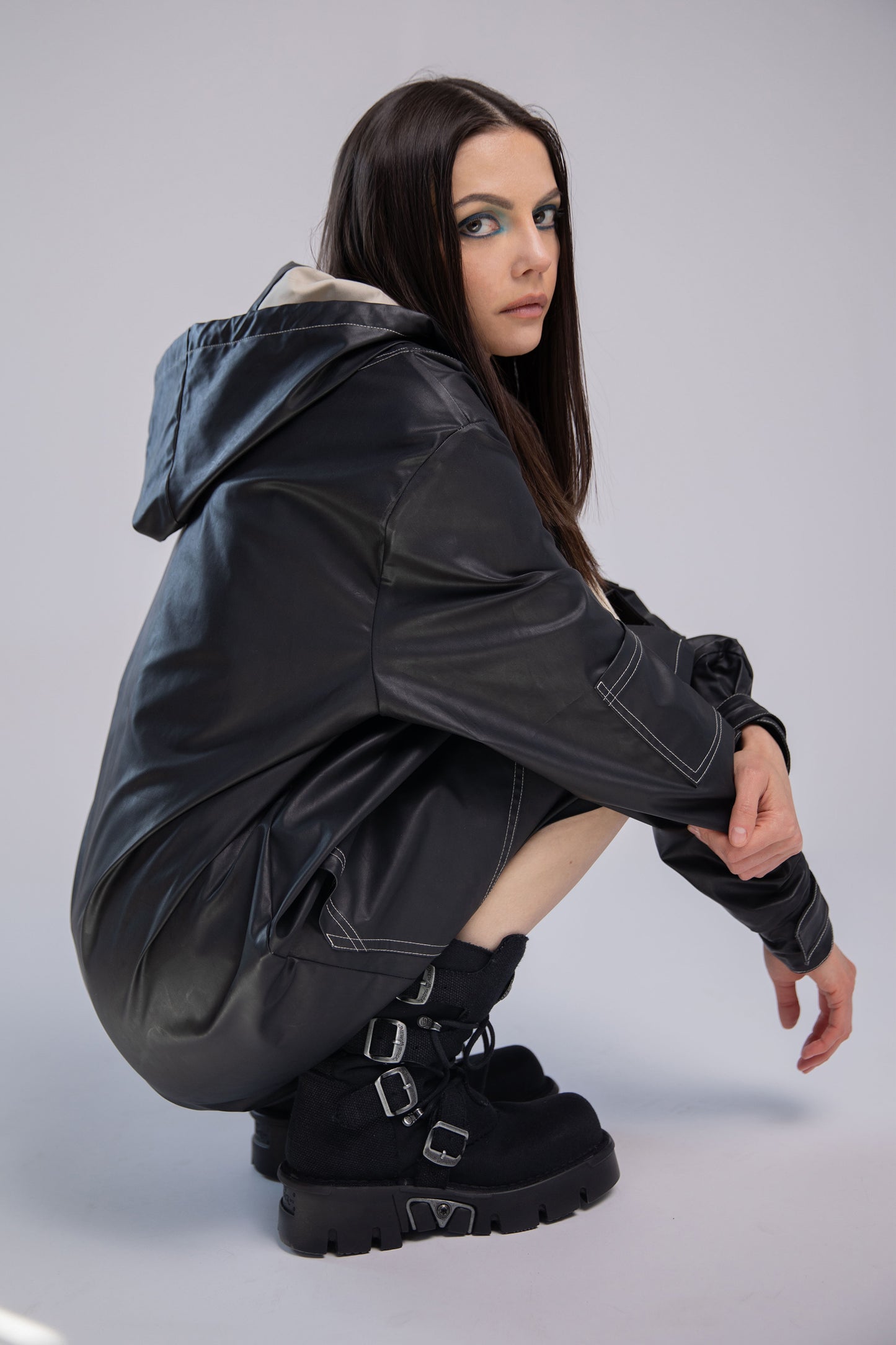 Model wearing Totem coat in dark grey with hood and relaxed fit