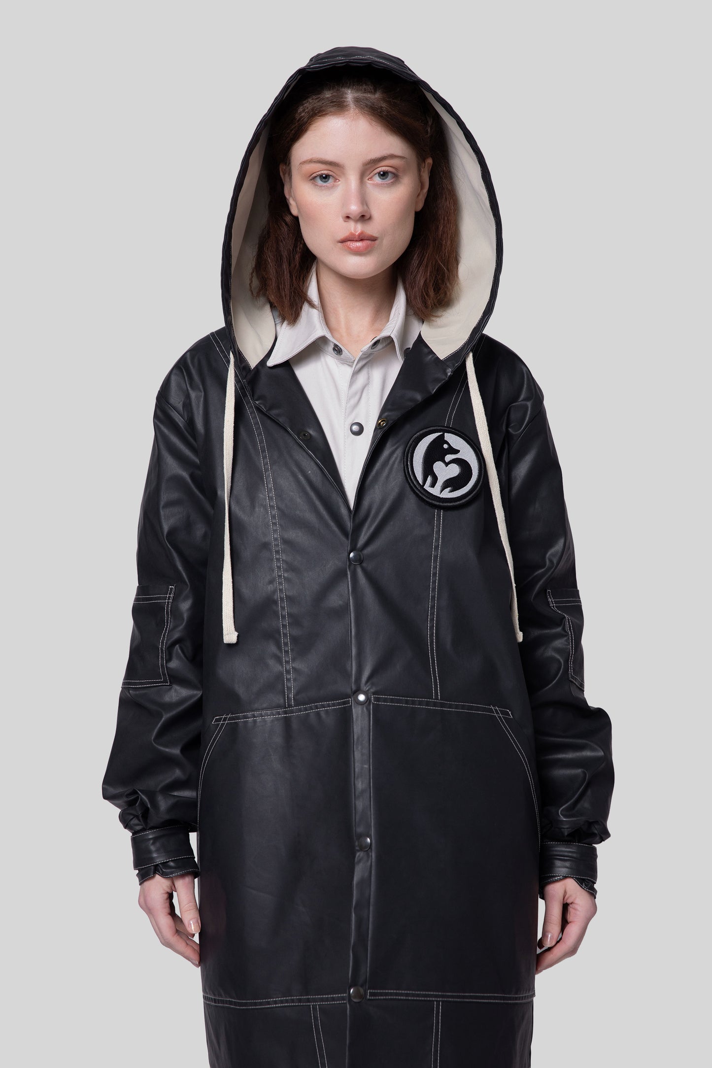 Front view of Totem coat in dark grey on model