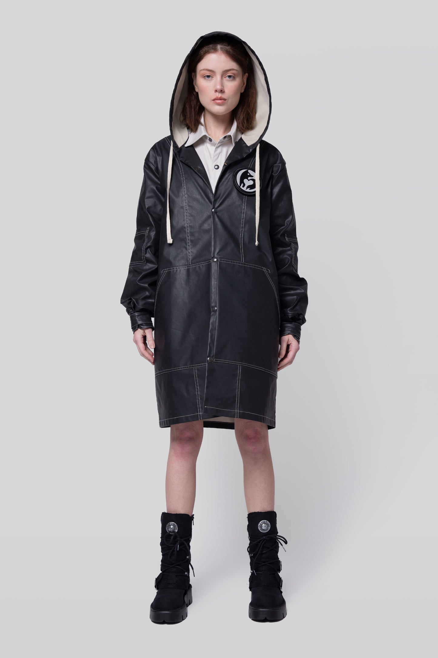 Full body view of Totem coat with structured hood