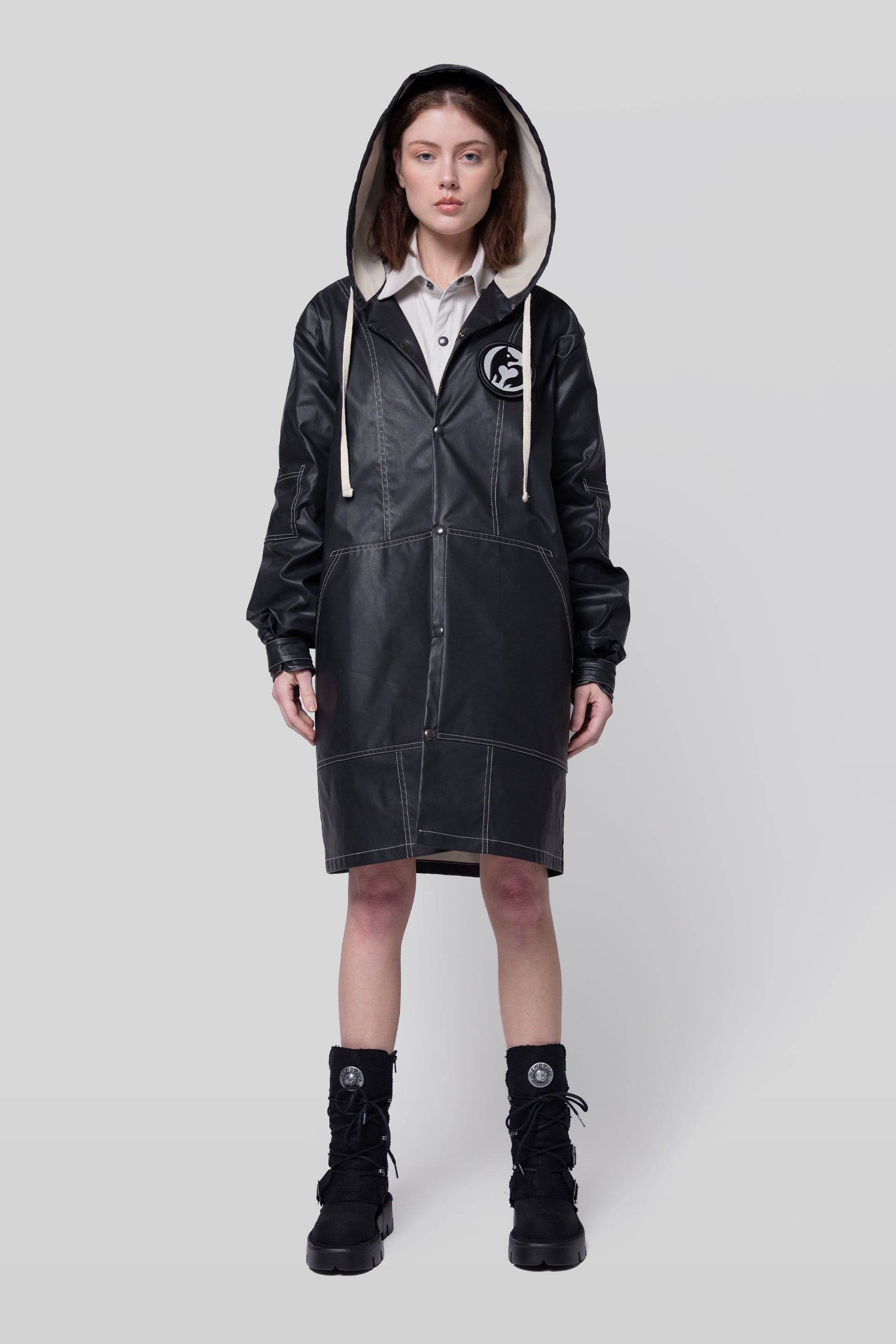 Full body view of Totem coat with structured hood