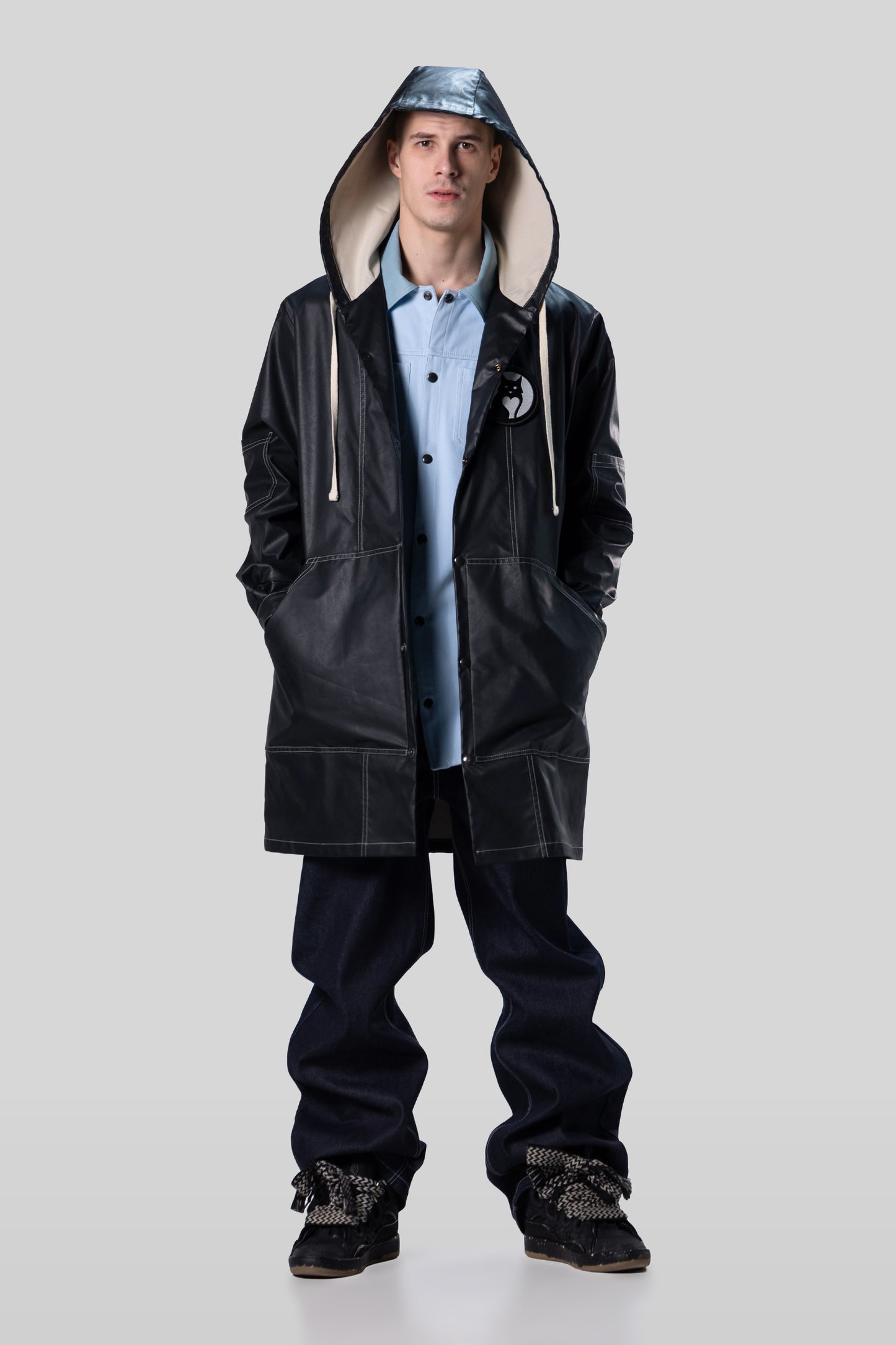 Full body view of Totem coat with hood up in dark grey