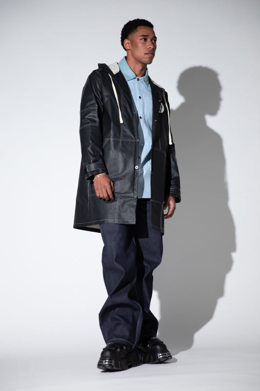 Full body view of Totem coat in dark grey with relaxed silhouette