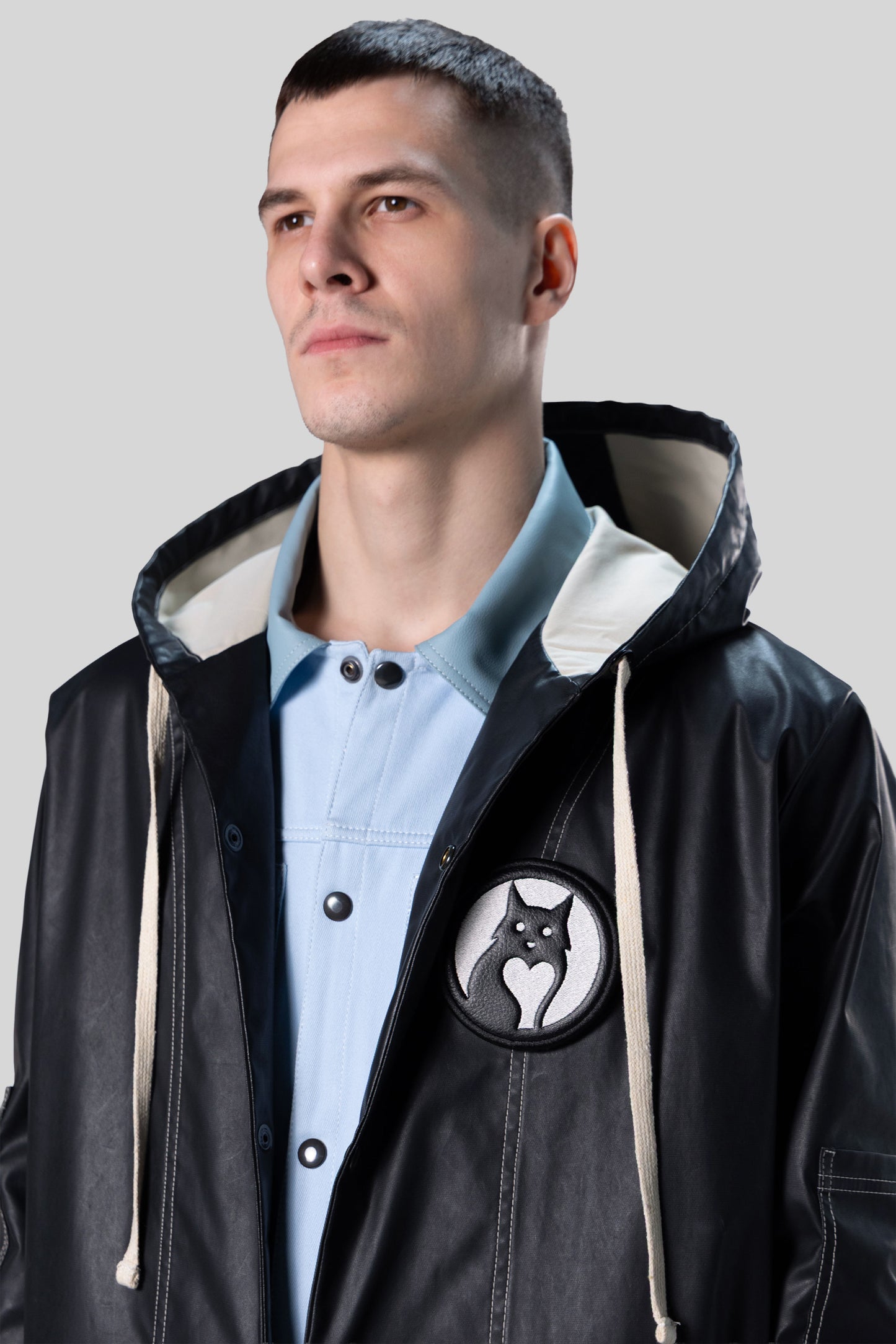 Portrait view of Totem coat in dark grey waterproof fabric