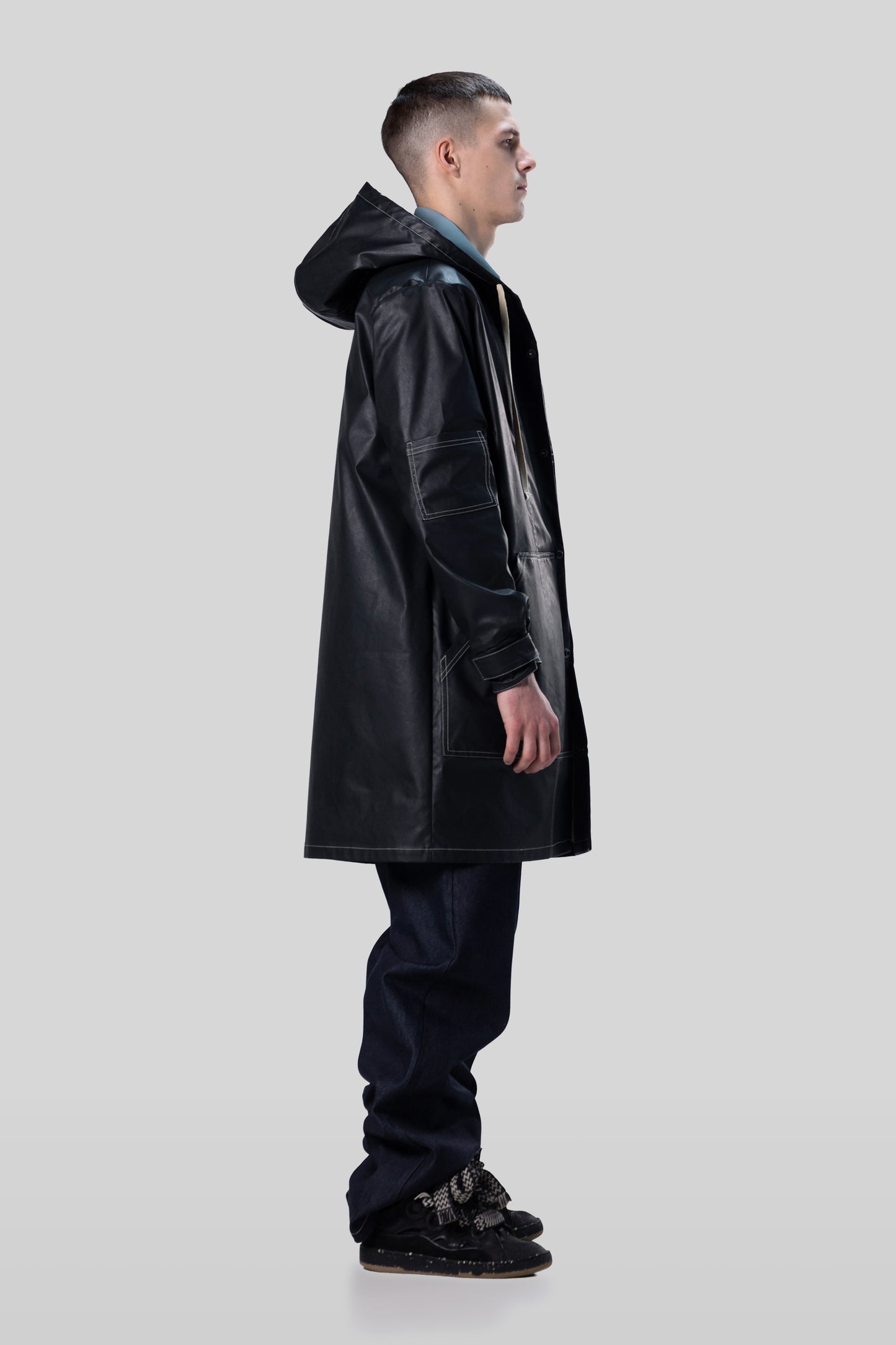 Side view of Totem coat in dark grey with structured hood